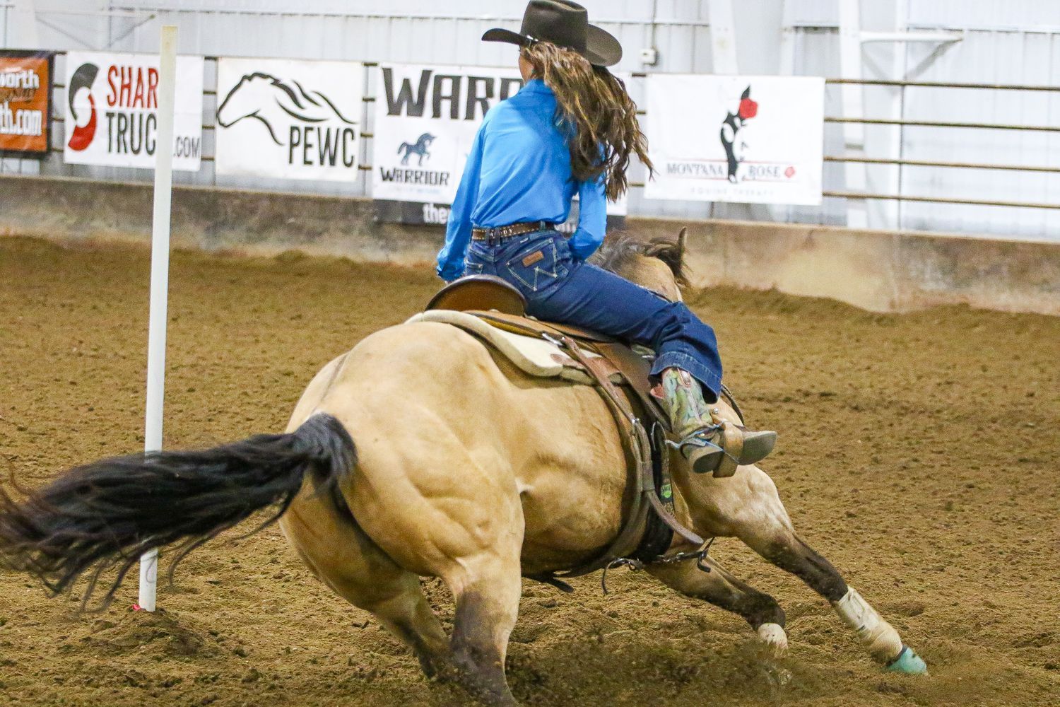A horse and rider rounding the first pole